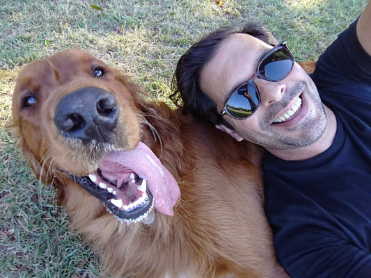 Hery and Rufus lying on the grass together taking a selfie